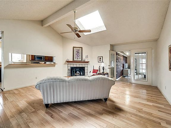 Skylight in vaulted-ceiling living room provides nice natural light.