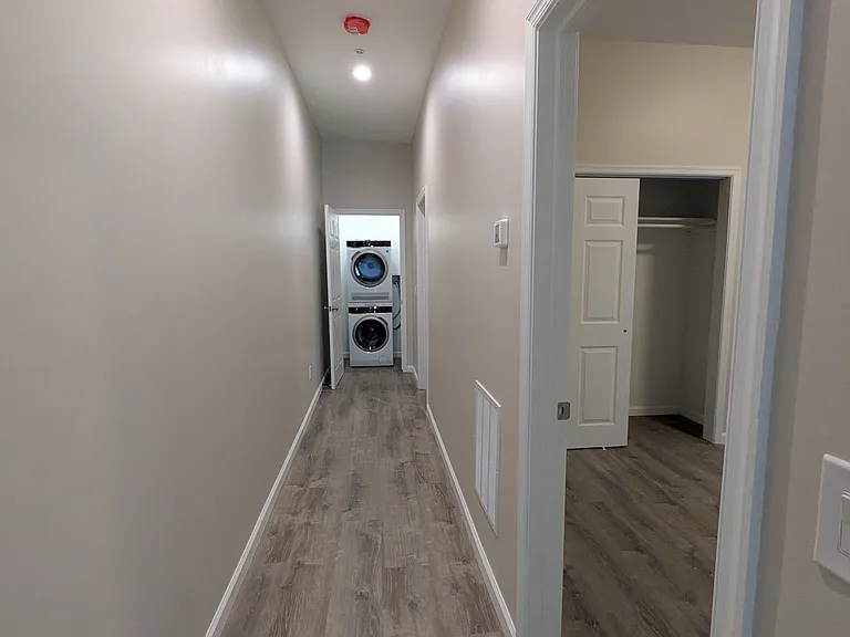 Hallway off the living room leads to 2 bedrooms and a brand new washer & dryer