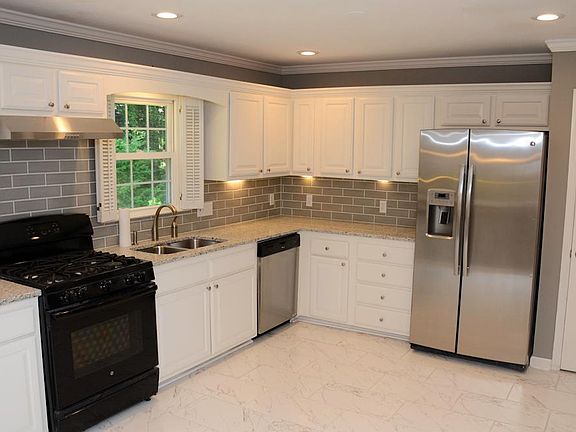 Kitchen. New / updated cabinets, new granite counter tops , new tile flooring, range hood, appliances, new backsplash and much more