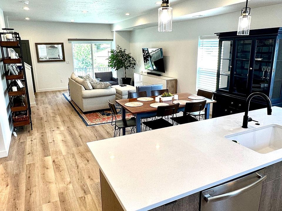 View from kitchen area towards living room and slider window with outside elevated deck.