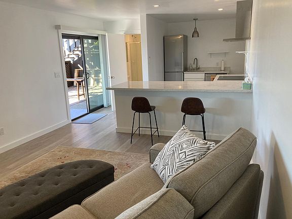 Interior: sliding glass door entrance, freshly painted, well lit, quartz counter top for eating and food preparation, can add furnishings