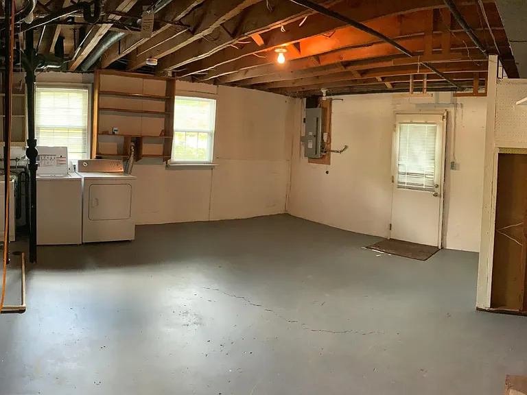 Laundry room, utility, and storage with a walkout door to the side yard - lower level
