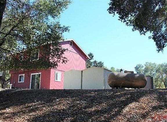 View of home, propane and storage sheds from the south west corn