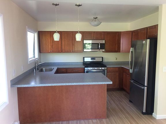 Kitchen has new cabinets, counters and updated stainless appliances