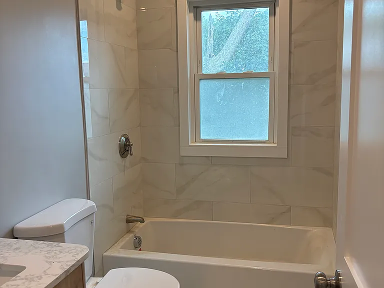 Bathroom - New tile floor, new tub, new tile around the tub, new sheetrock, new insulation, new vanity, new plumbing, and electrical.