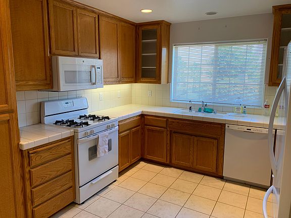 Kitchen with gas stove and microwave.