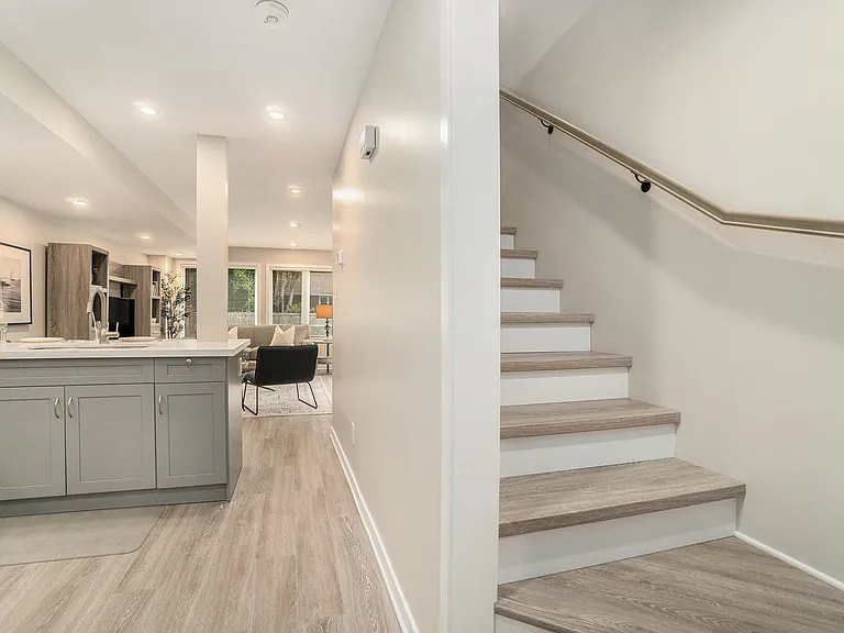 Modern staircase and hallway layout in our professionally managed Ottawa furnished rental.