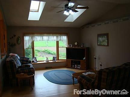 First floor living room : Sky lights, hardwood floors and a great view out bay window.