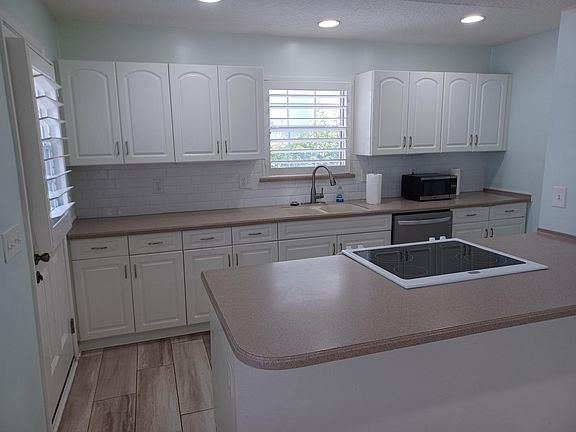 Bright kitchen with door onto patio for outside entertaining