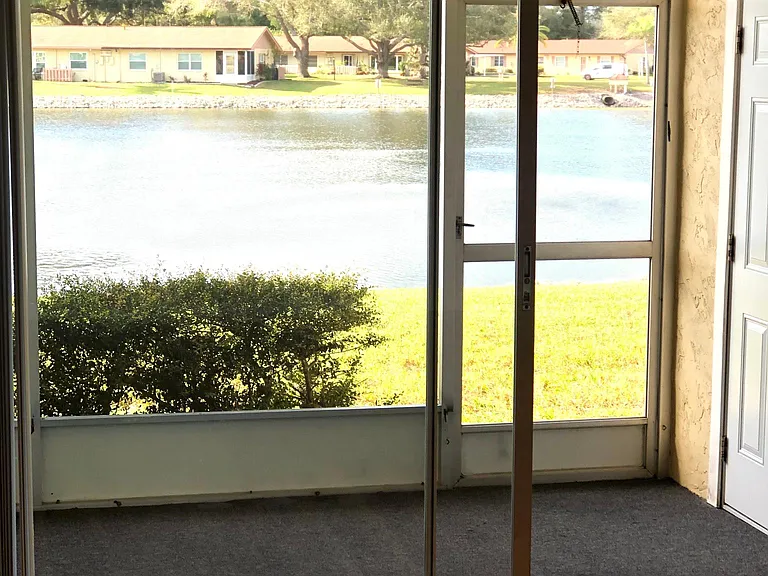 STUNNING LAKE VIEWS FROM LIVING ROOM THROUGH LANAI SLIDERS