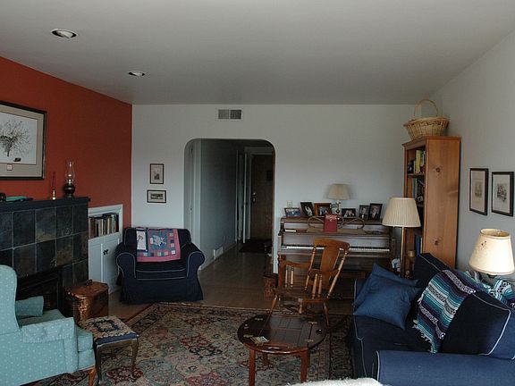 Living room photo taken from deck. Note the original curved doorways. 
