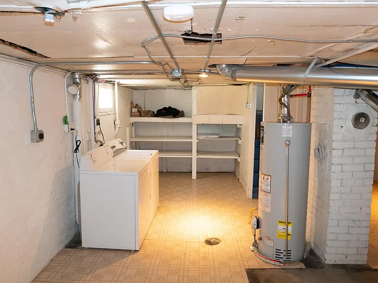 Basement Southside with washer and dryer. Storage shelves in the background.