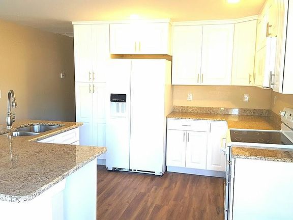 Beautiful solid wood white cabinets with granite countertops.