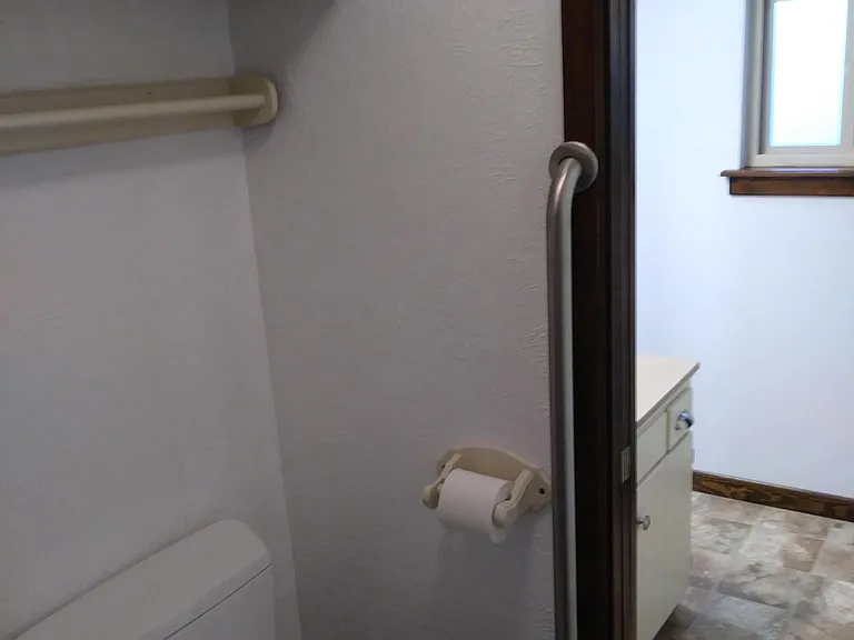 Toilet and shower separated from sink with a pocket door.