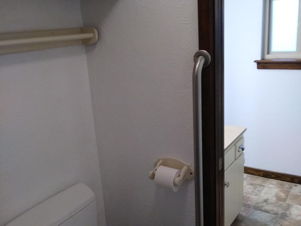 Toilet and shower separated from sink with a pocket door.