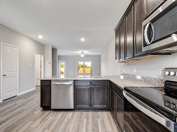 Enjoy stunning granite countertops and designer wood cabinetry in this kitchen.