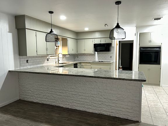 Open concept kitchen and living room. Great for entertaining or keeping an eye on the kiddos while cooking. Granite countertops and enough room for 4-6 bar stools.