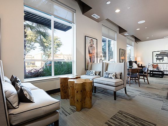 Coffee lounge with sofa, arm chairs, and tables.