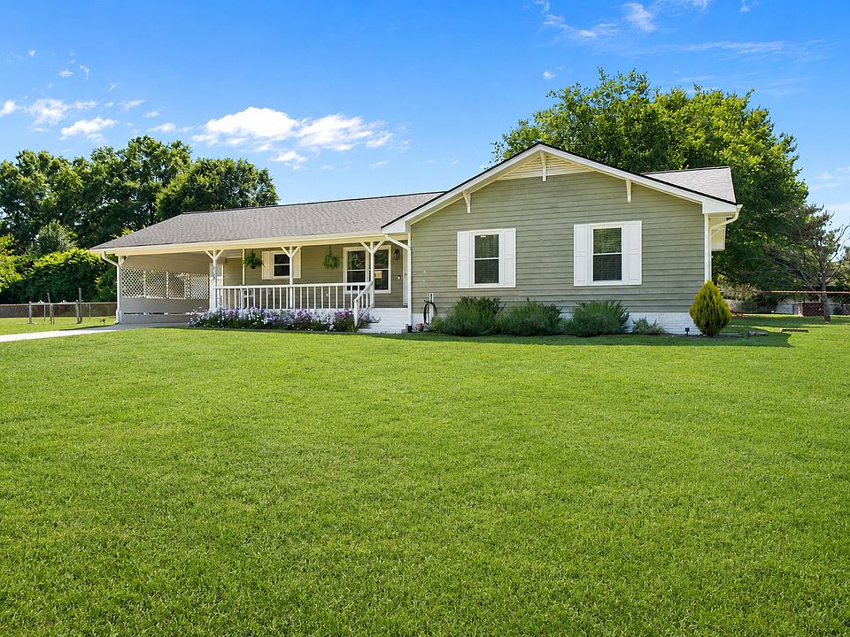Front - Extended porch and swing - carport - 2 entrances