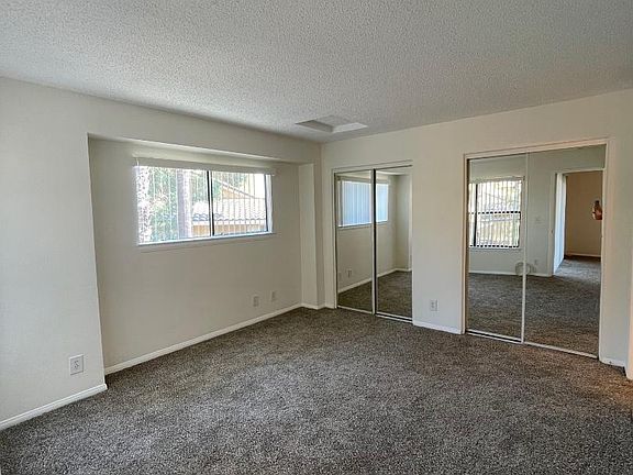 Bedroom with Mirrored Closet Doors
