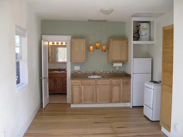 Kitchen area, refrigerator, stove, and pantry.