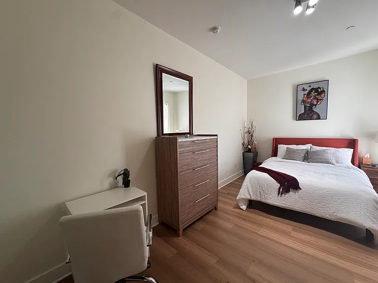 Work space and queen bed in bedroom 2