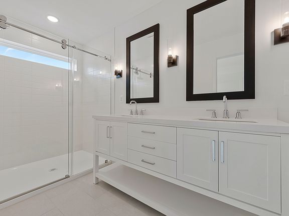 Primary bath featuring freestanding vanity with dual sinks