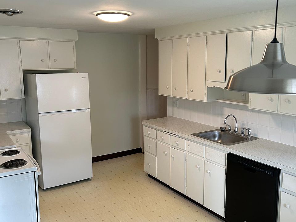 Large working kitchen has room for small table and chairs.
