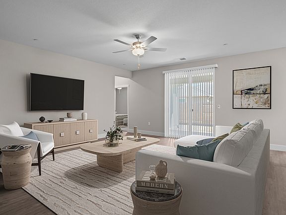 The family room is spacious with a ceiling fan.