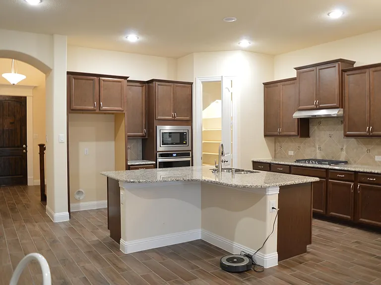 Large kitchen with natual gas cooktop and microwave.