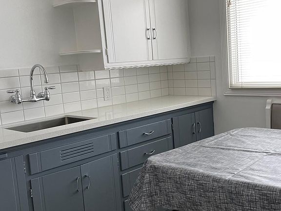New tile, countertops, sink and faucet in charming kitchen.