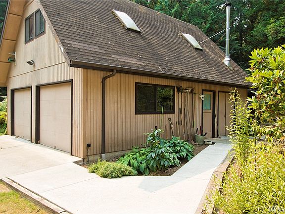 Pathway to the garage and shop space also leads to a storage shed for your lawn mower. This garden is full of blooming surprises and fragrances.