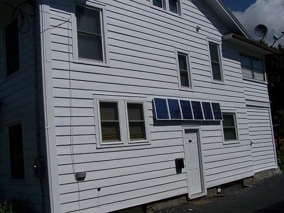 Driveway side w/ solar panels.