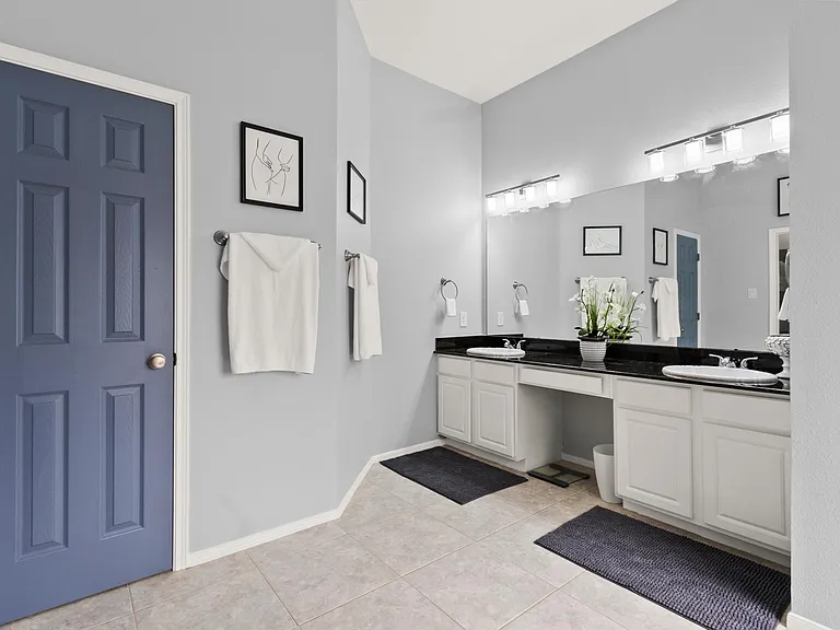 Long dual sinks and built in linen closet