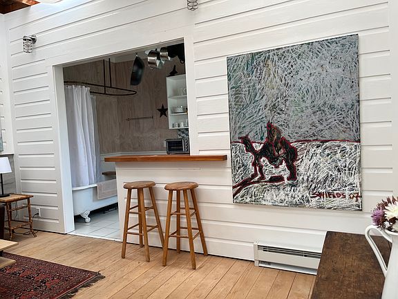 Walking into the cottage, you are greeted by views of the bar and kitchen beyond to your left
