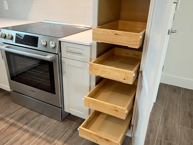 Smartly designed pull-out pantry cabinet featuring multiple deep, soft-close drawers_perfect for organized storage, easy access, and maximizing kitchen functionality with a clean, modern look.