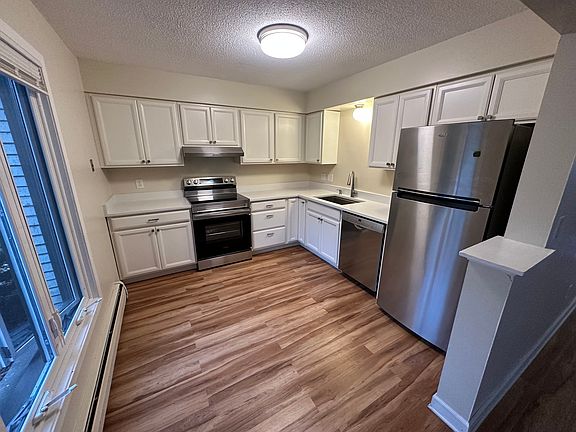 Kitchen with many recent updates! Quartz Counters, Workstation Sink, Bosch Dishwasher, new Stove and Range Hood