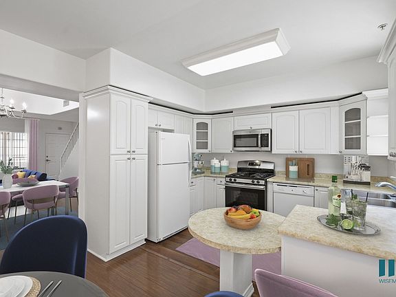 Kitchen with Countertop Bar, Refrigerator, Stove, Microwave Oven, and Dishwasher