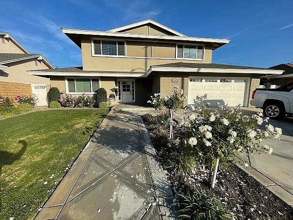 Front of house. Three car driveway and 2 car garage.