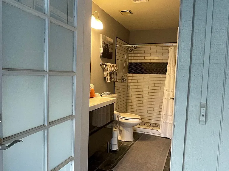 Master bathroom door opens to the back patio