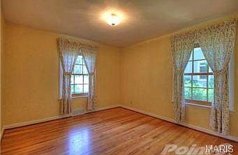 Bedroom 2 with wood floor and newer windows