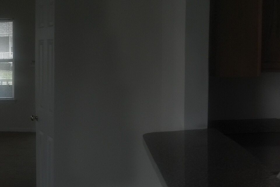 Panaromic view of kitchen and living room