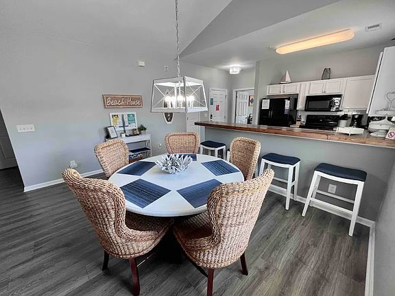 Dining table has seating for six (extra chair not pictured) and four more seats at the breakfast bar. Time for a meal or an evening board game!