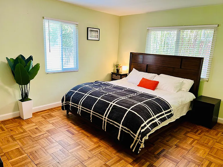 Master Bedroom with a King-sized Bed and a large dresser with mirror.