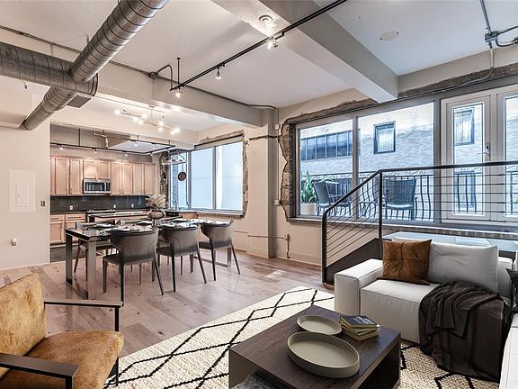 Stylish and sophisticated loft in the heart of Downtown with great features and finishes. Great 2 level floor plan has living, dining, kitchen, private balcony and 1/2 bath down. Upstairs is the spacious master suite! This photo is virtually staged.