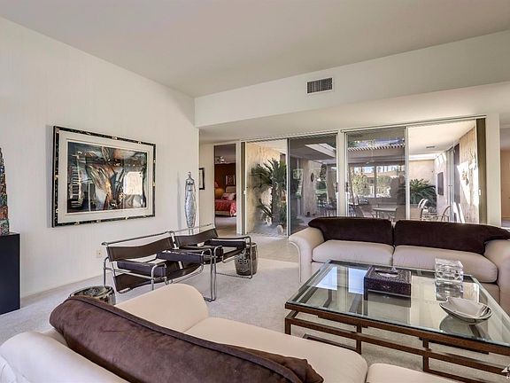 The main living area boasts a wall on sliding doors looking out on to the interior patio area, allowing for your maximum enjoyment of the desert sunlight.