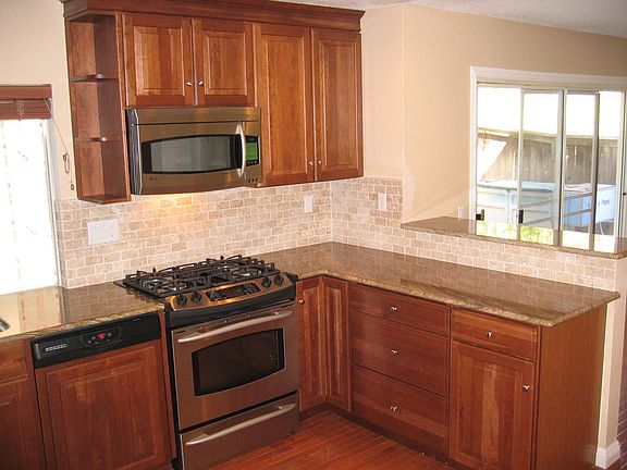 New appliances, granite and stone backsplash