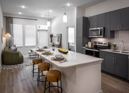 Discover ample space for meal prep and entertaining with the expansive chef's kitchen island at Modera Garden Oaks. - Modera Garden Oaks