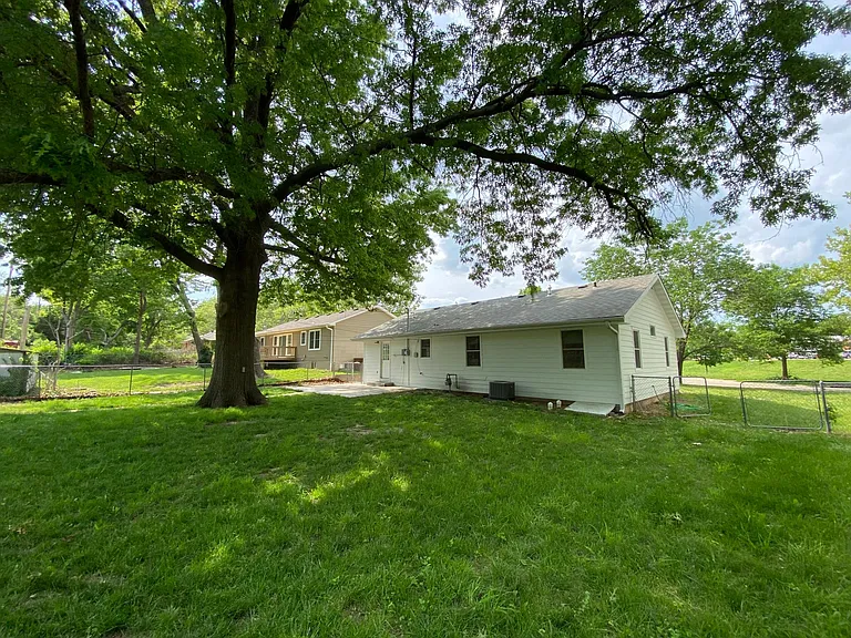 Double gate access on east side of house to backyard.