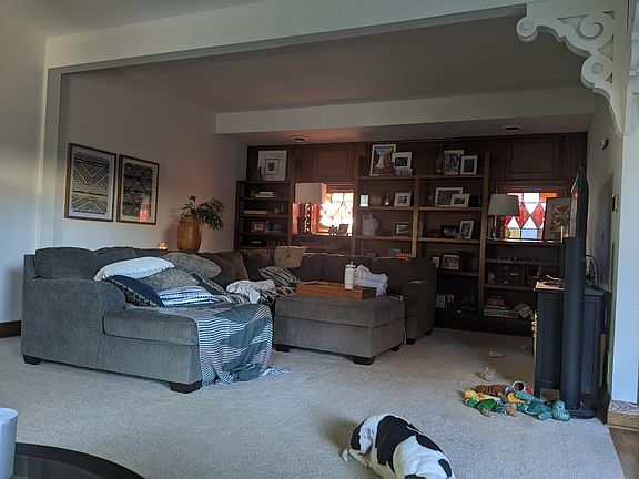 Living room during the day. Stained glass windows by bookcase
